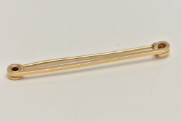 A YELLOW METAL BAR BROOCH, polished bar, fitted with a brooch pin and C clasp, stamped 14k, length