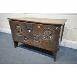 A 16TH/17TH CENTURY OAK SIX PLANK BOARDED CHEST, with a carved masks within a circle, and two