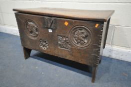 A 16TH/17TH CENTURY OAK SIX PLANK BOARDED CHEST, with a carved masks within a circle, and two