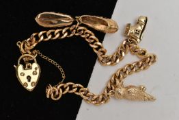 A 9CT GOLD CHARM BRACELET, yellow gold curb link bracelet, fitted with a heart padlock clasp, also