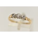 A THREE STONE DIAMOND RING, a principle round brilliant cut diamond with two single cut diamonds,