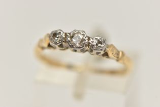 A THREE STONE DIAMOND RING, a principle round brilliant cut diamond with two single cut diamonds,