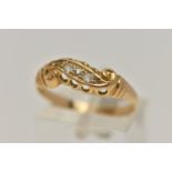 A YELLOW METAL DIAMOND RING, set with five graduated diamonds, within a scroll mount, leading onto a