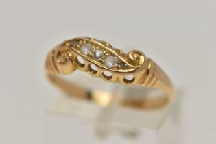 A YELLOW METAL DIAMOND RING, set with five graduated diamonds, within a scroll mount, leading onto a
