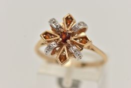 A 14CT GOLD GEM SET RING, abstract design, set with a central oval cut garnet, with citrine and