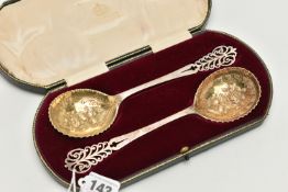A CASED PAIR OF EDWARDIAN ELKINGTON & CO SILVER FRUIT SPOONS, gilt circular bowls chased and