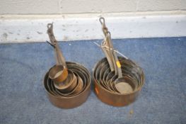 TWO SETS OF SEVEN COPPER GRADUATED PANS, (condition report: aged wear and tear) (2)