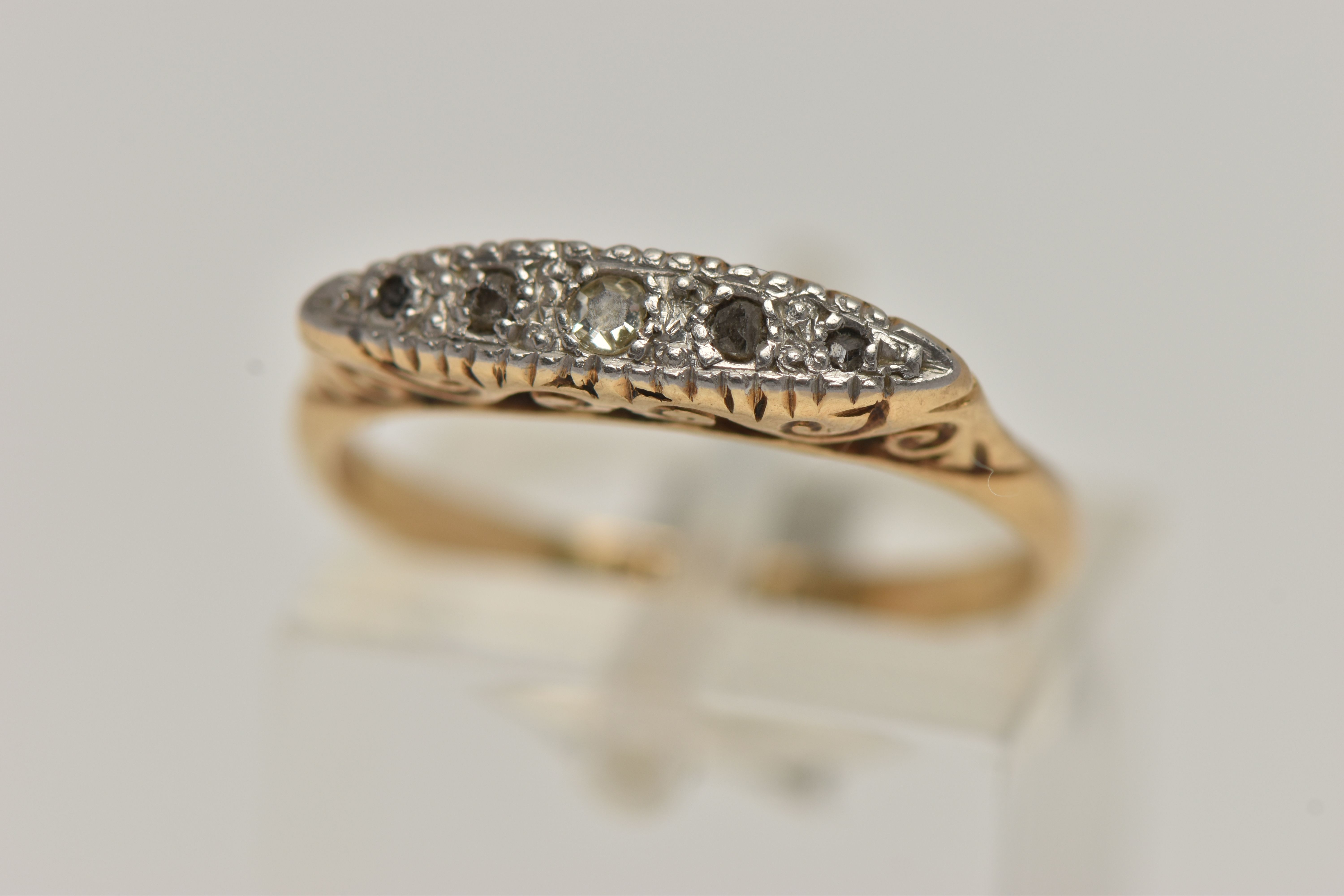 A YELLOW METAL DIAMOND RING, set with five diamonds, one single cut and four rose cut diamonds, in a