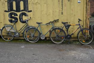 AN ALPINA YELLOW AND PURPLE BICYCLE, with a 22 inch frame, and two green vintage bicycles (condition