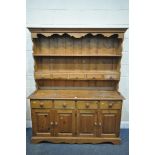 A PINE DRESSER, with two shelves, with five drawers, over a base with four drawers, width 152cm x