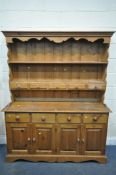 A PINE DRESSER, with two shelves, with five drawers, over a base with four drawers, width 152cm x