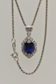 A WHITE METAL PENDANT NECKLACE, the pendant set with an oval cut synthetic blue sapphire in a