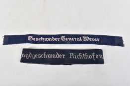 TWO GERMAN UNIFORM WRIST CUFF TITLES, both are dark blue and were worn of Luftwaffe uniforms, the