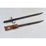 A TWENTIETH CENTURY JAPANESE BAYONET, this is housed in a metal scabbard and comes with its frogs,