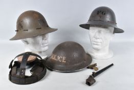 THREE MILITARY STEEL HELMETS AND SPIKE BAYONET, the helmets include a 1939 dated helmet with