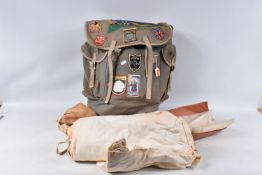 A VINTAGE HIKERS BACKPACK AND A CAMP BED, the backpack has the metal support in the back and has