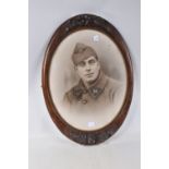 A FRAMED PHOTO OF A FRENCH SOLDIER, the picture is in a carved wooden frame and features a French