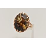 A LARGE 9CT GOLD SMOKY QUARTZ DRESS RING, oval cut smoky quartz, double claw set within an open work