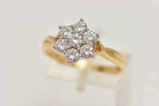 A 18CT GOLD DIAMOND CLUSTER RING, seven round brilliant cut diamonds, prong set in white gold,