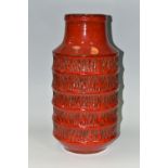A JASBA POTTERY VASE OF RIBBED CYLINDRICAL FORM, red glazed with textured vertical lines between the