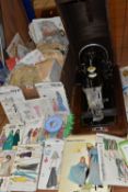 TWO VINTAGE SEWING MACHINES AND A QUANTITY OF SEWING PATTERNS, to include a wooden cased Singer