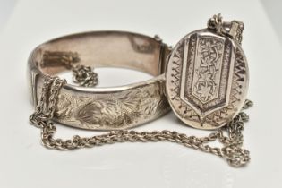 A SILVER LOCKET AND CHAIN WITH A BANGLE, oval foliage pattern hinged locket, hallmarked Birmingham