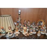 A COLLECTION OF TWENTY TWO GOEBEL HUMMEL FIGURES, A HUMMEL LAMP WITH SHADE AND A HUMMEL REUGE