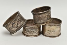 FOUR SILVER NAPKIN RINGS, each with a different design, each hallmarked with Bristish hallmarks,