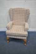 A HSL BEIGE UPHOLSTERED WING BACK ARMCHAIR, on front cabriole legs, width 66cm x depth 72cm x height