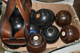 A BOX CONTAINING TWELVE CROWN GREEN BOWLING BALLS IN WOOD EFFECT AND BLACK PLASTIC, two by Thomas