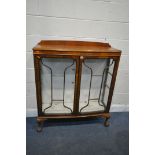 A WALNUT TWO DOOR CHINA CABINET, enclosing two glass shelves, width 105cm x depth 36cm x height