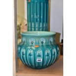 A BRETBY JARDINIERE AND STAND, an arts and crafts style turquoise glazed pottery jardiniere with a