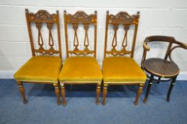 THREE EDWARDIAN DINING CHAIRS, with shaped backrest, gold upholstered seat pads, on turned front