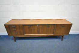 A MID CENTURY G PLAN TEAK SIDEBOARD, with three drawers and a fall front door, flanking two bifold