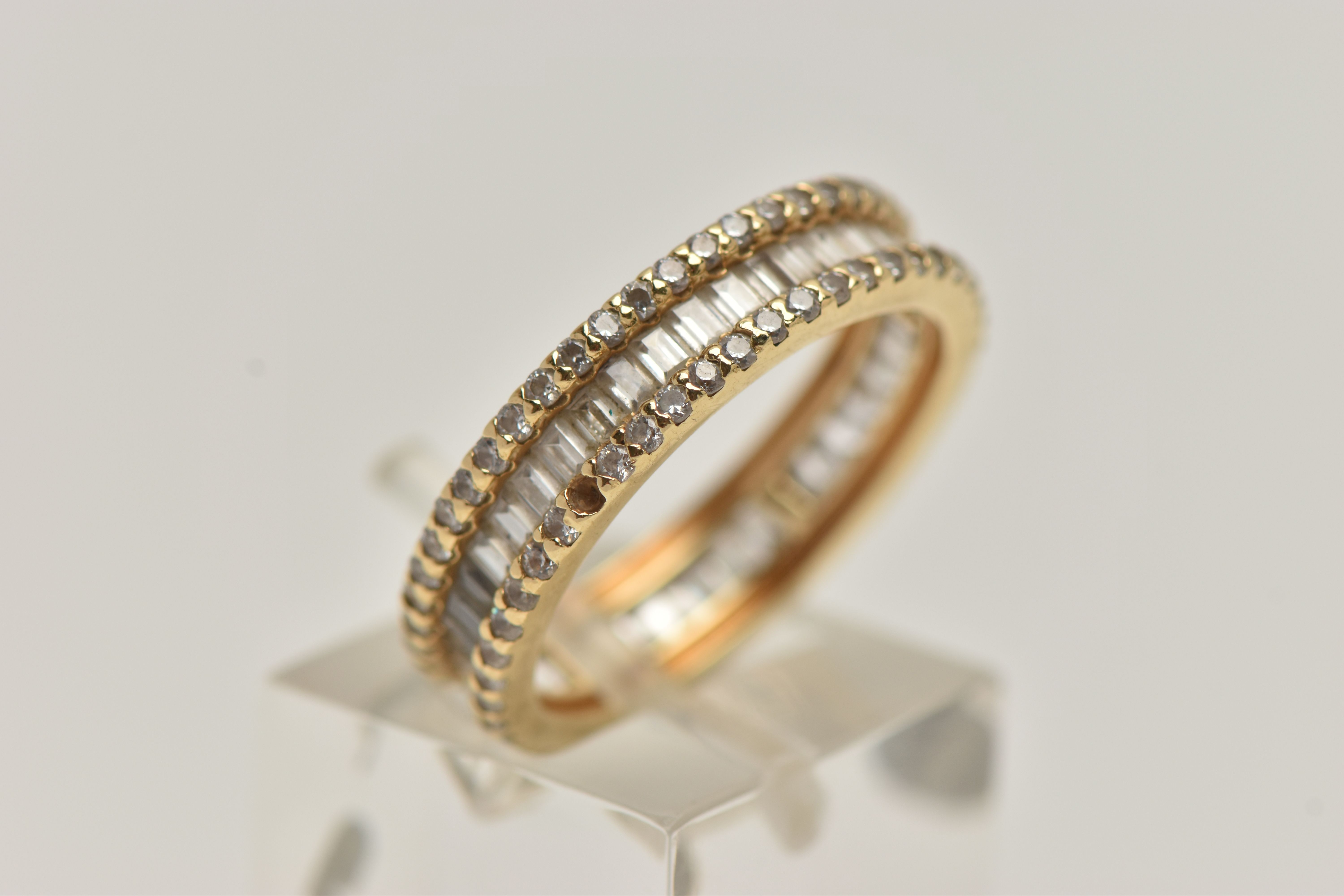 A YELLOW METAL DIAMOND BAND RING, set with a central row of baguette cut diamonds, between two - Image 4 of 4