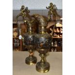 A PAIR OF BRONZED BRASS EWERS, decorated with a bacchanalian design, Putti and grapevine, height