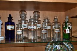 A COLLECTION OF ELEVEN CLEAR AND COLOURED PHARMACY BOTTLES, all with glass labels and glass