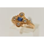 A YELLOW METAL SAPPHIRE AND DIAMOND RING, centring on a rectangular cut blue sapphire, collet set,