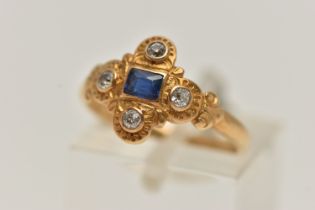 A YELLOW METAL SAPPHIRE AND DIAMOND RING, centring on a rectangular cut blue sapphire, collet set,