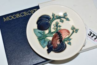 A BOXED MOORCROFT PIN DISH DECORATED WITH BIRDS AND PLUMS, impressed marks, diameter 12cm (1 +