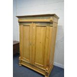 A FRENCH STYLE PINE PANELLED TWO DOOR WARDROBE, width 131cm x depth 65cm x height 189cm (condition