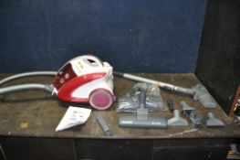 A RED AND WHITE HOOVER CURVE VACUUM CLEANER, with accessories (condition report: PAT pass and