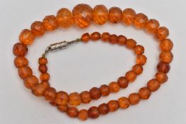 A GRADUATED FACETED COPAL AMBER BEAD NECKLACE, fitted with a white metal magnetic clasp, length