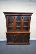 A VICTORIAN STYLE MAHOGANY GLAZED THREE DOOR BOOKCASE, over a base with three drawers and cupboard