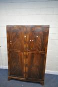 A 20TH CENTURY FLAME MAHOGANY DOUBLE DOOR WARDROBE, with four shelves inside, width 123cm x depth