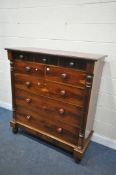 A VICTORIAN FLAME MAHOGANY CHEST OF NINE ASSORTED DRAWERS, on turned legs, width 125cm x depth