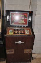 A VINTAGE 'LEEDS' SLOT MACHINE with 'Penny Duel' graphics, width 67cm x height 140cm (untested and