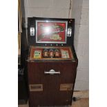 A VINTAGE 'LEEDS' SLOT MACHINE with 'Penny Duel' graphics, width 67cm x height 140cm (untested and