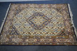A 20TH CENTURY WOOLEN RUG, with a central medallion, repeating patterns, on a cream field, with a