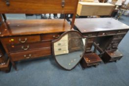 AN EDWARDIAN MAHOGANY DRESSING TABLE, with a shield mirror, and nine drawers, width 124cm x depth